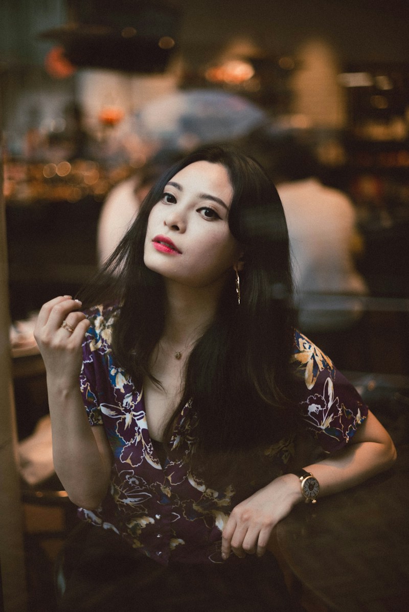 Editorial portrait of a woman in a warmly lit café